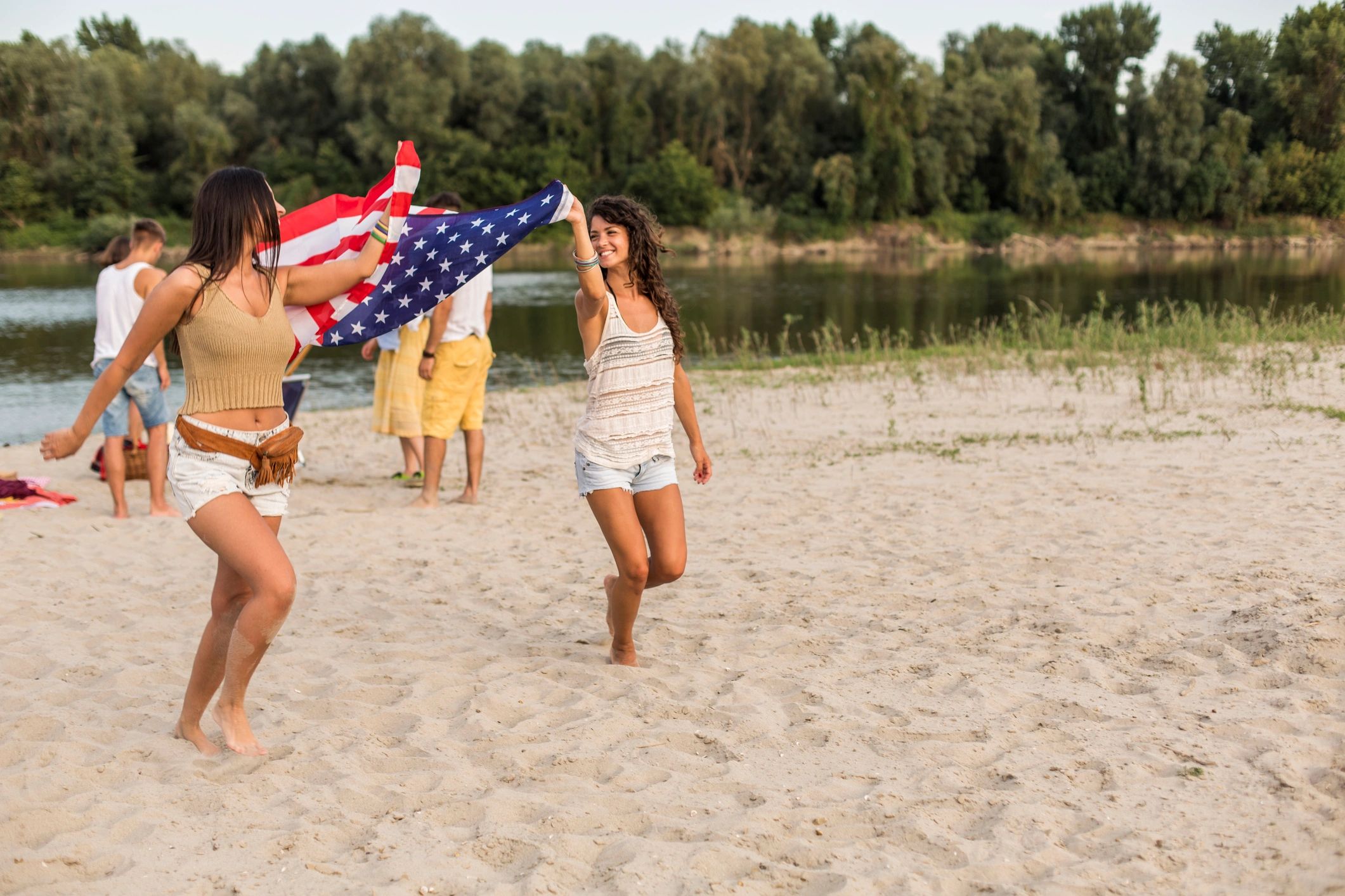 People celebrating with a large American flag