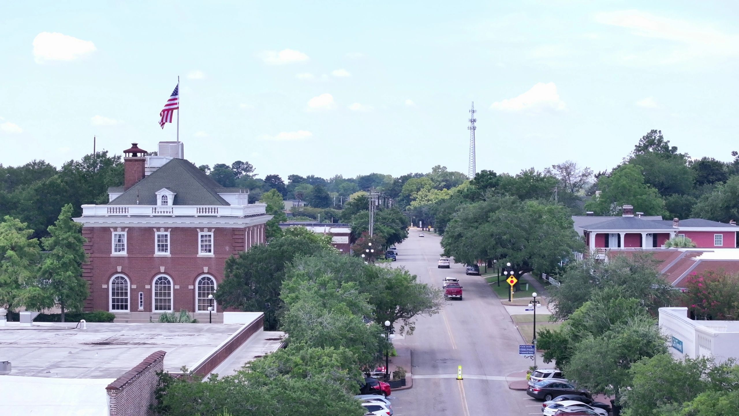 Historic downtown street with American flag and brick architecture